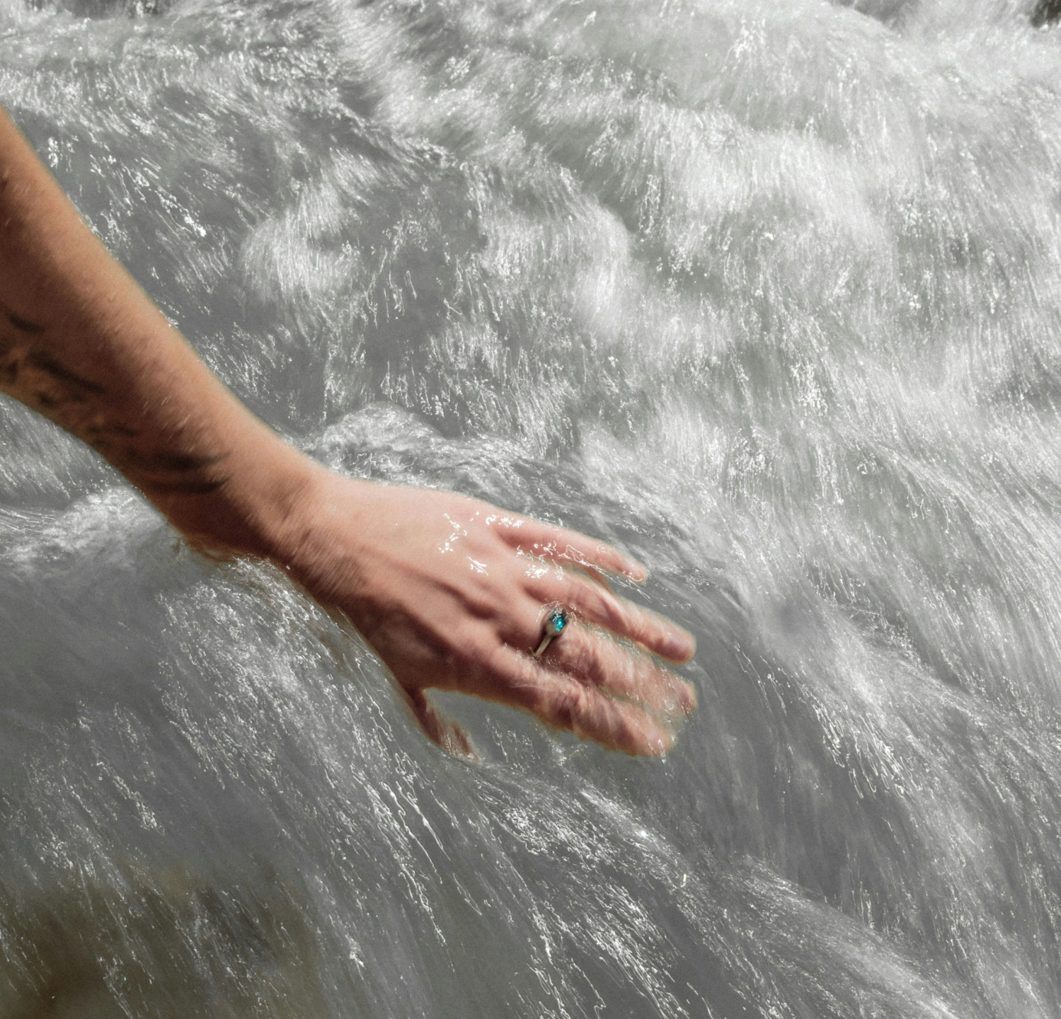 woman's hand in a large body of water 