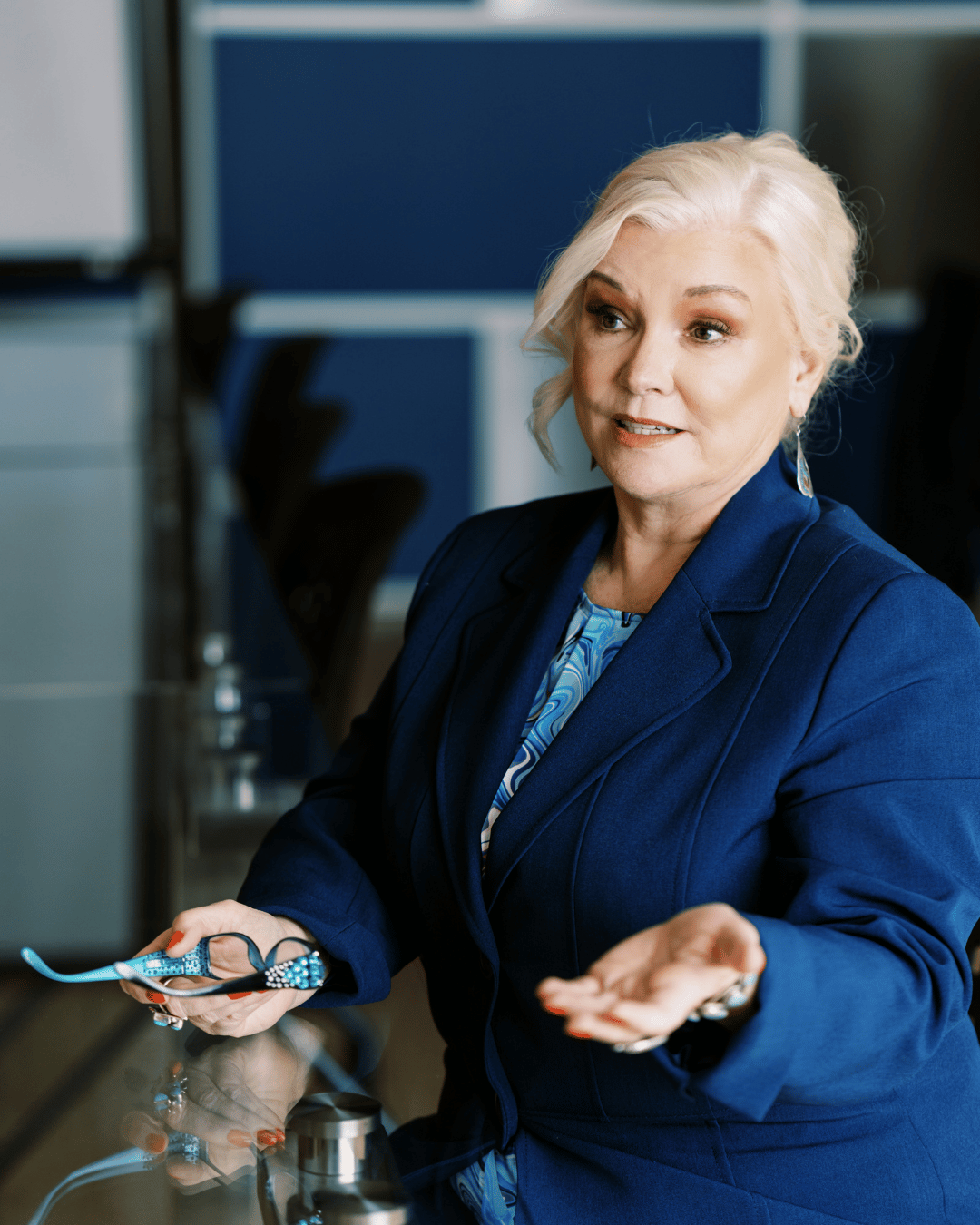 Debbie leaning on chair looking into camera