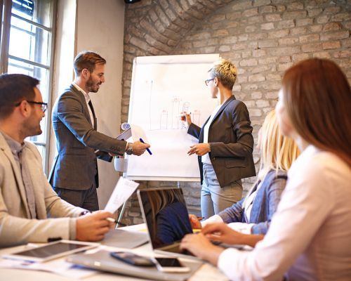 500 x 400 Meeting, presenting on large white paper.