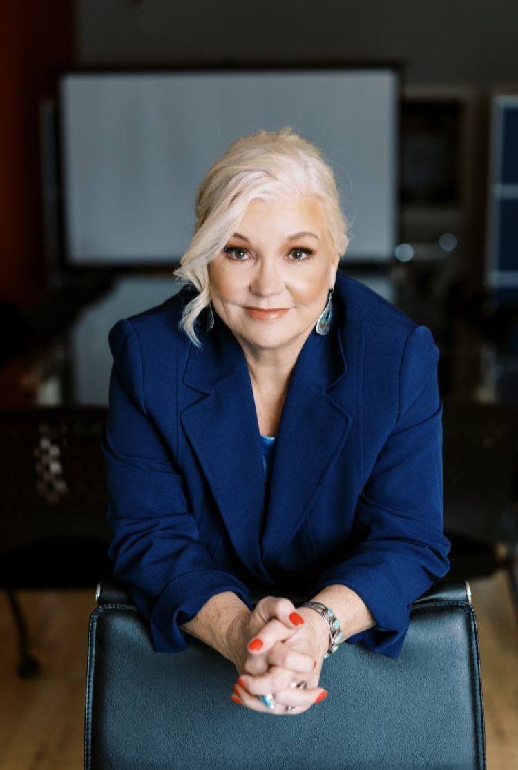 Debbie on couch looking into camera