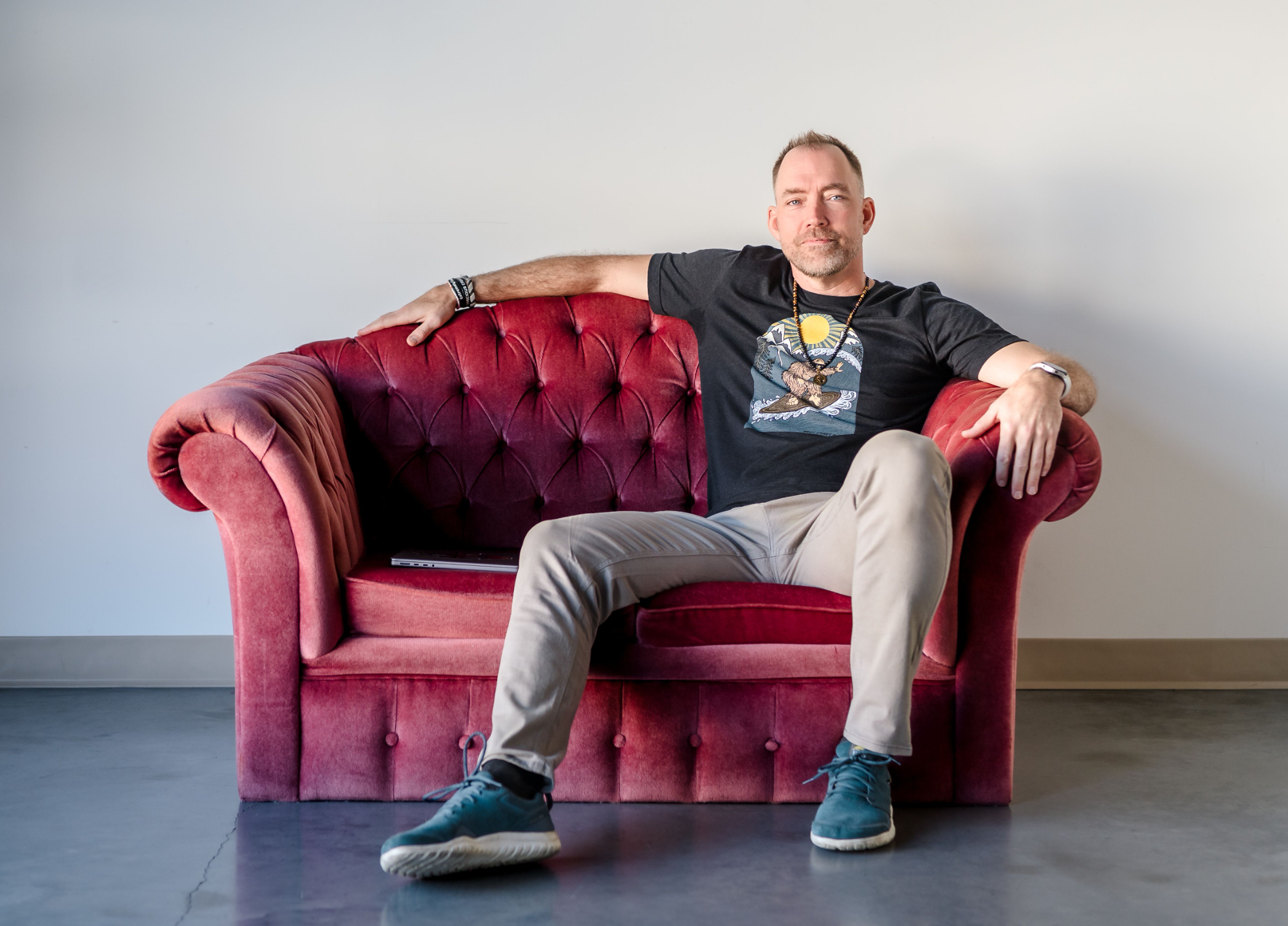 Trevor Turnbull present The Elevated CEO | Sitting on a pink couch, expressing the life first, business second mentality