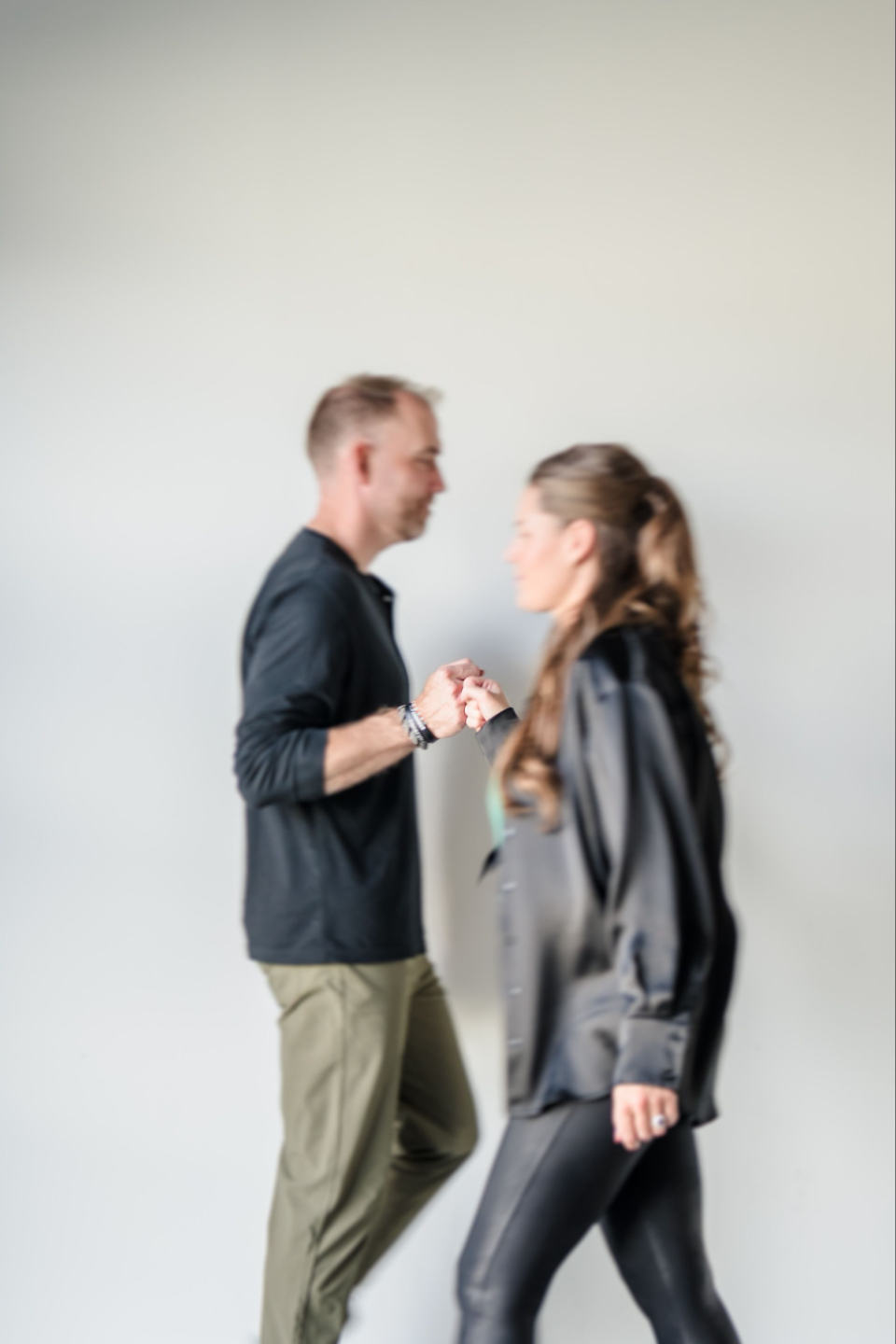 Danielle Grant (Your Mindset Mentor) & Trevor Turnbull (Elevated CEO) walking past each other as they fist pump and celebrate a client win