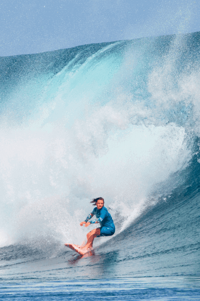 Woman surfer sitting out swells
