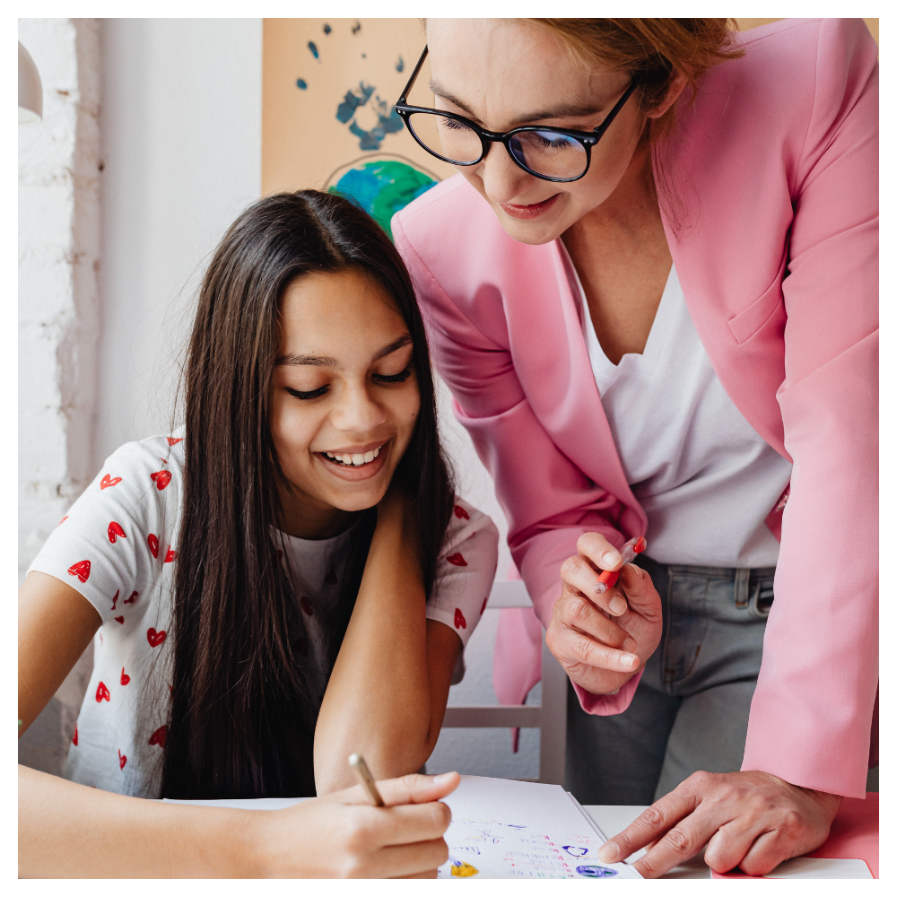 Mother helping her daughter with a learning activity at home, encouraging connection, confidence, creativity, and intentional family rhythms inspired by Serenely Rooted.