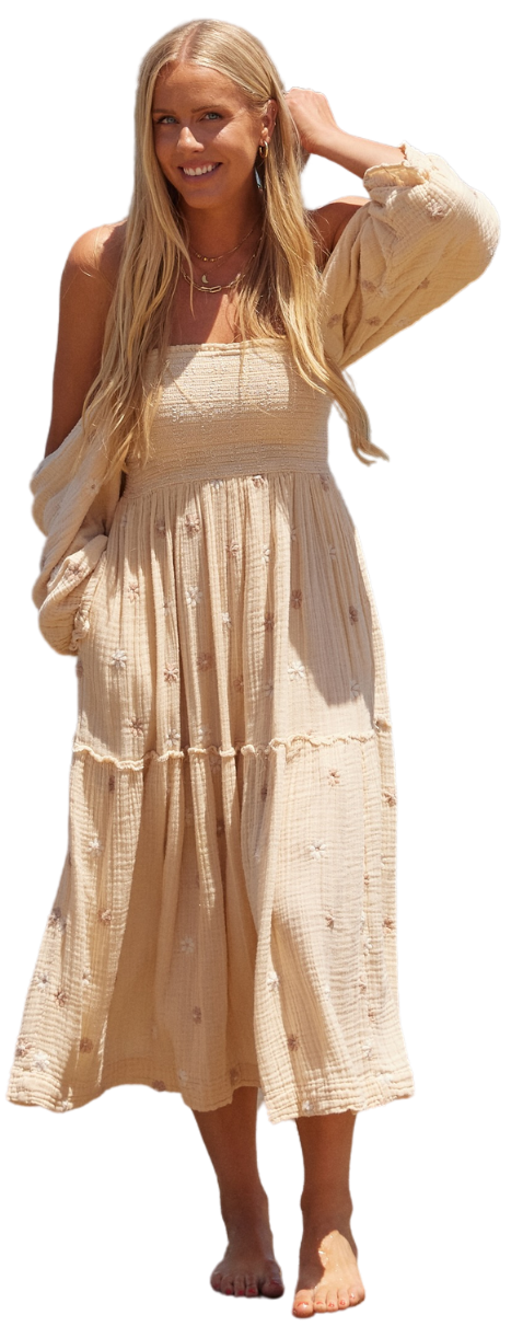 Alissa standing confidently in a blue dress, smiling at the camera
