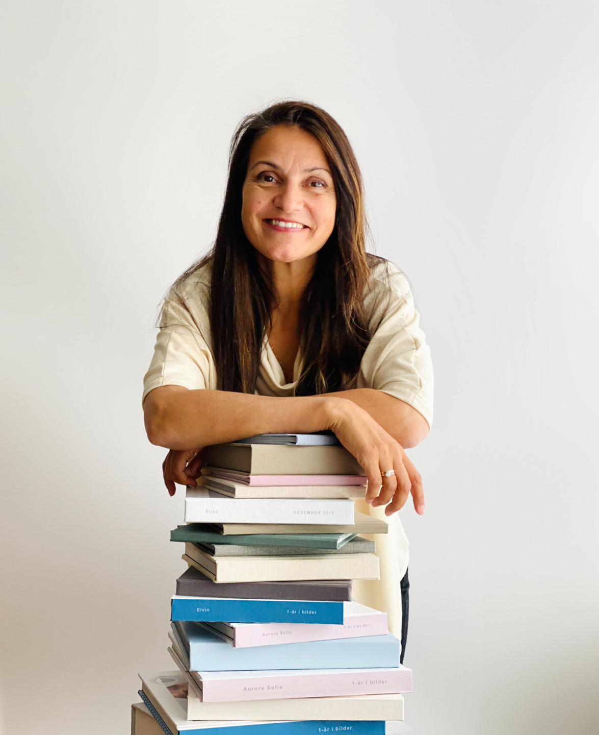 Kvinnelig Seo coach som sitter på barkrakk med laptop i fanget og smiler