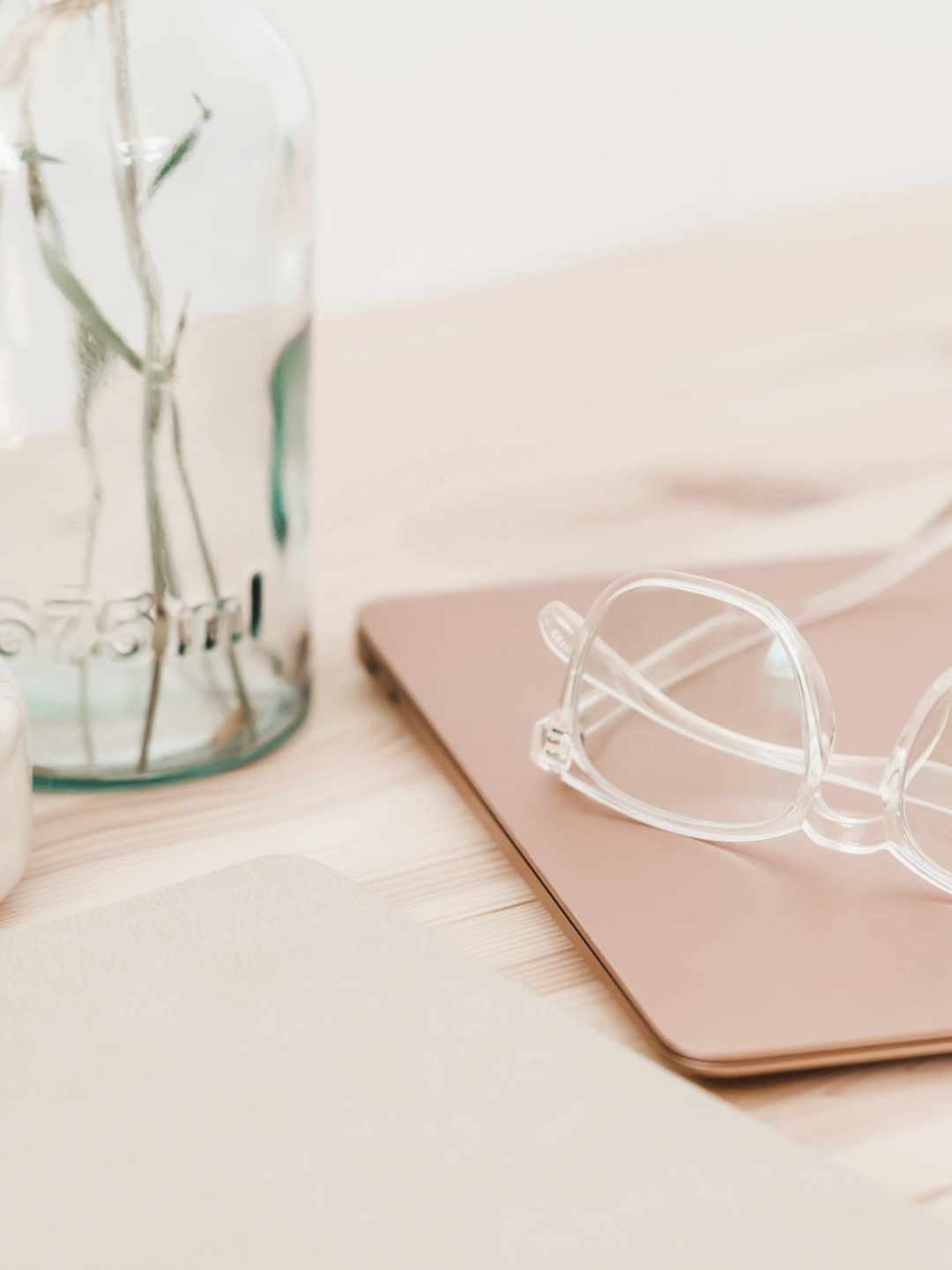 Glasses and tablet on desk