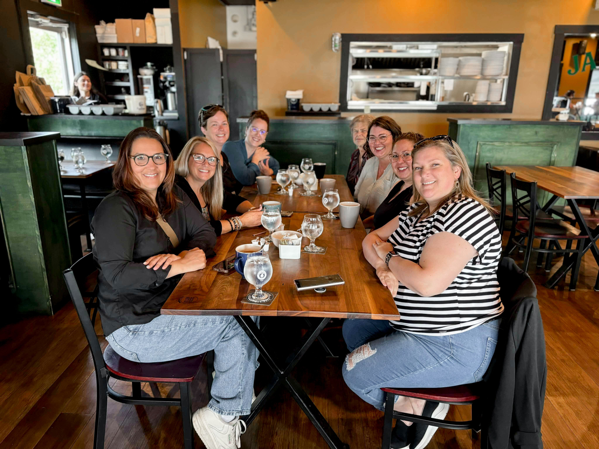 Three women business owners having genuine conversation at The Roundabout networking event in Saint John New Brunswick