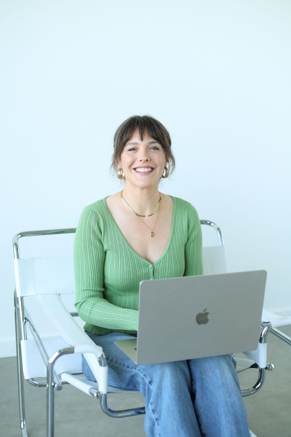 woman sitting on floor in black boots and red dress