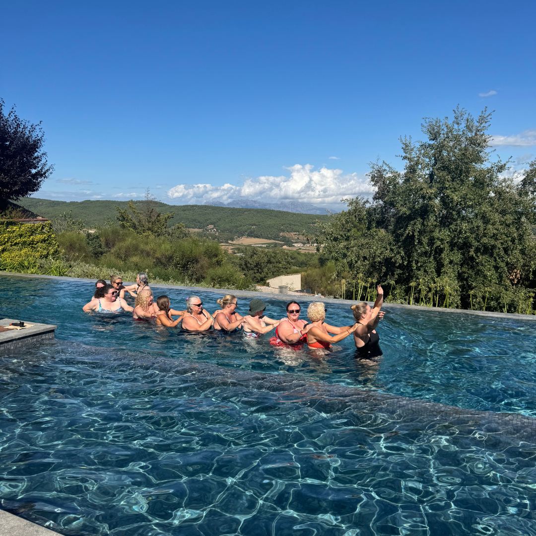 A female guest wearing a white bathrobe descends steps at Yourself Yoga’s menopause wellness retreat near Barcelona.