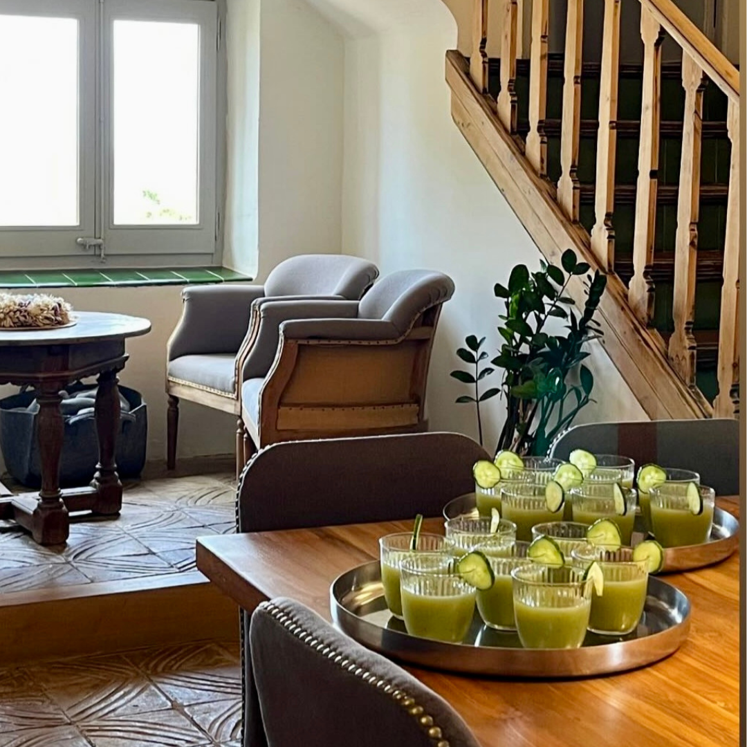 A seating area in the bodega with exposed stone walls at Yourself Yoga’s menopause wellness retreat near Barcelona.