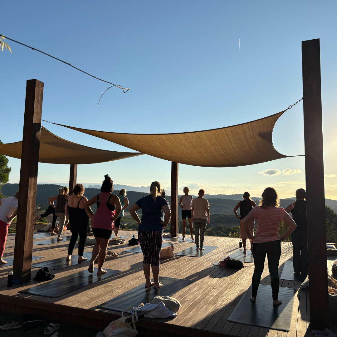 A shaded outdoor yoga platform with Montserrat mountain views in Spain at Yourself Yoga’s menopause wellness retreat.