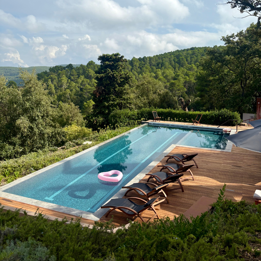 A dark wood arched window in a Catalan ‘masia, the venue for Yourself Yoga’s menopause wellness retreat in Spain.