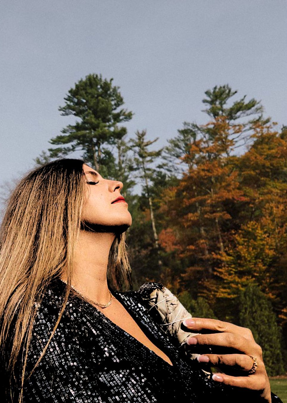 woman holding a burning sage looking up