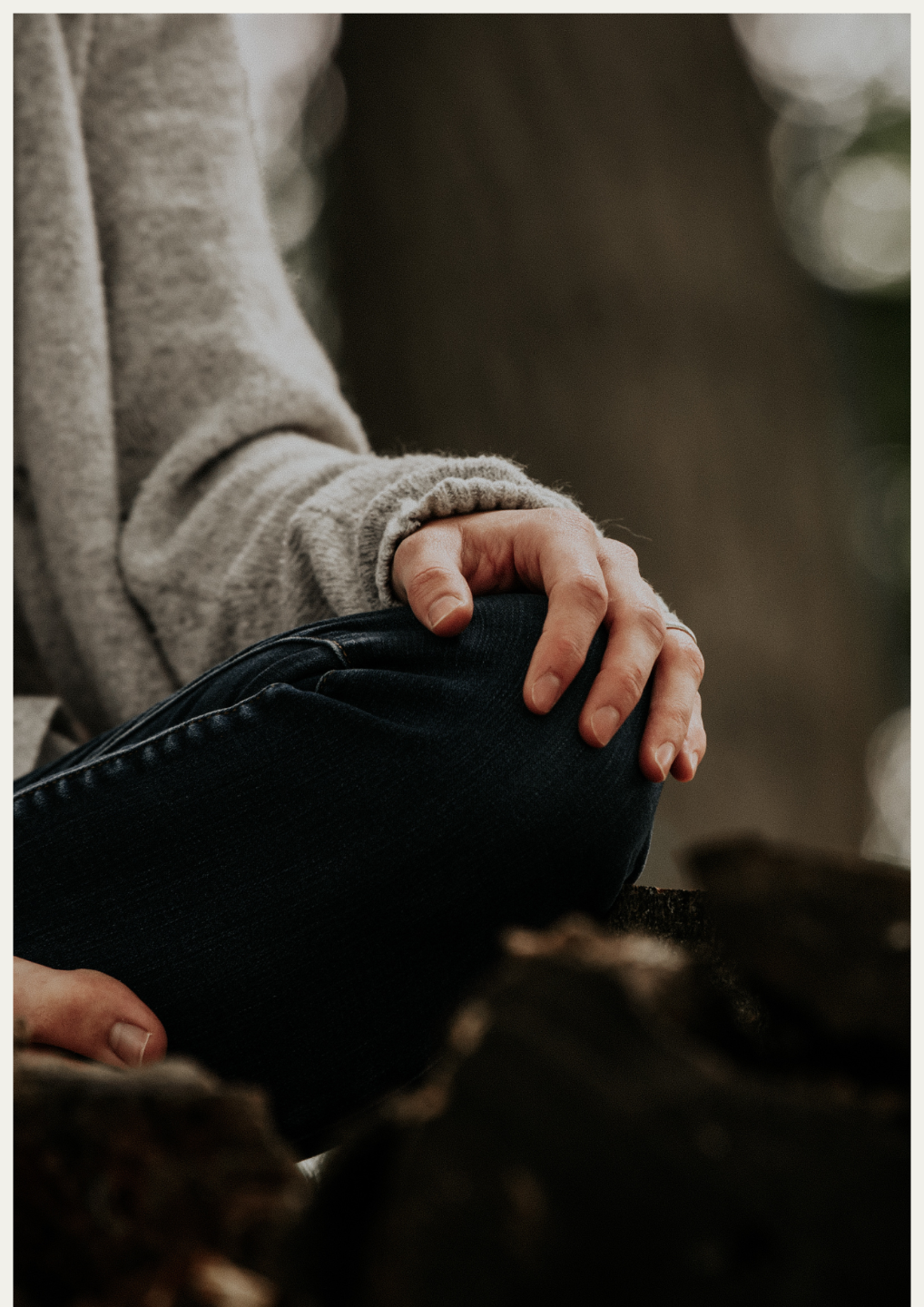 Hand die rust op een knie, symbool voor terugkeren naar jezelf.