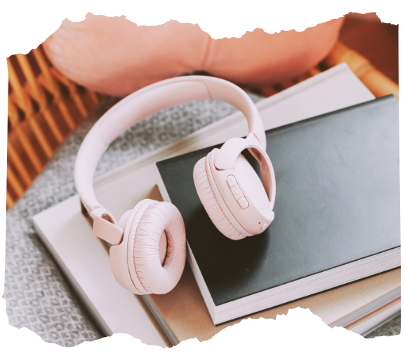 Headphones resting on a laptop, illustrating streaming video lessons, guided journeys, and audio recordings included in the shamanic course.