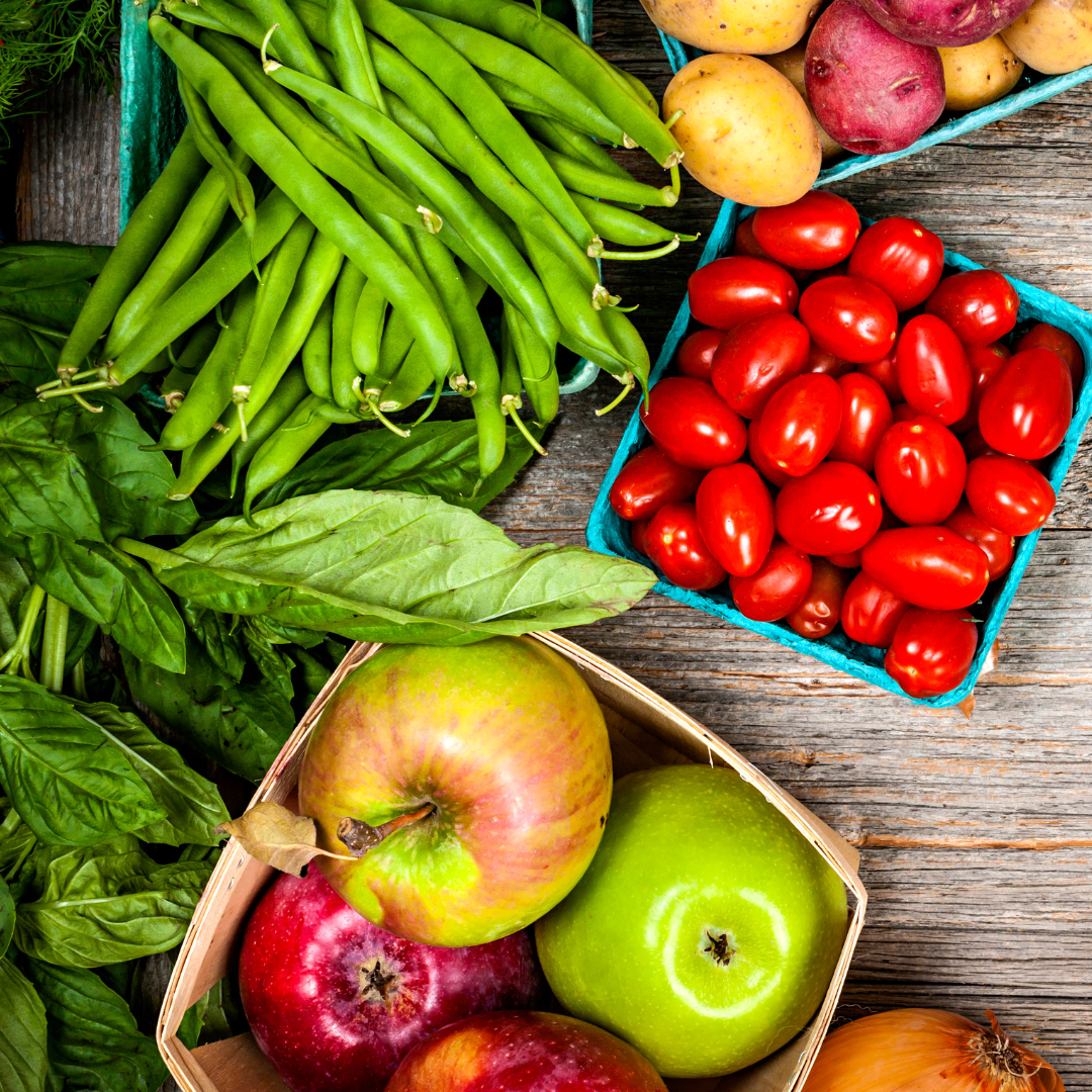 Stock image of tomatoes, apples, green beans and basil.