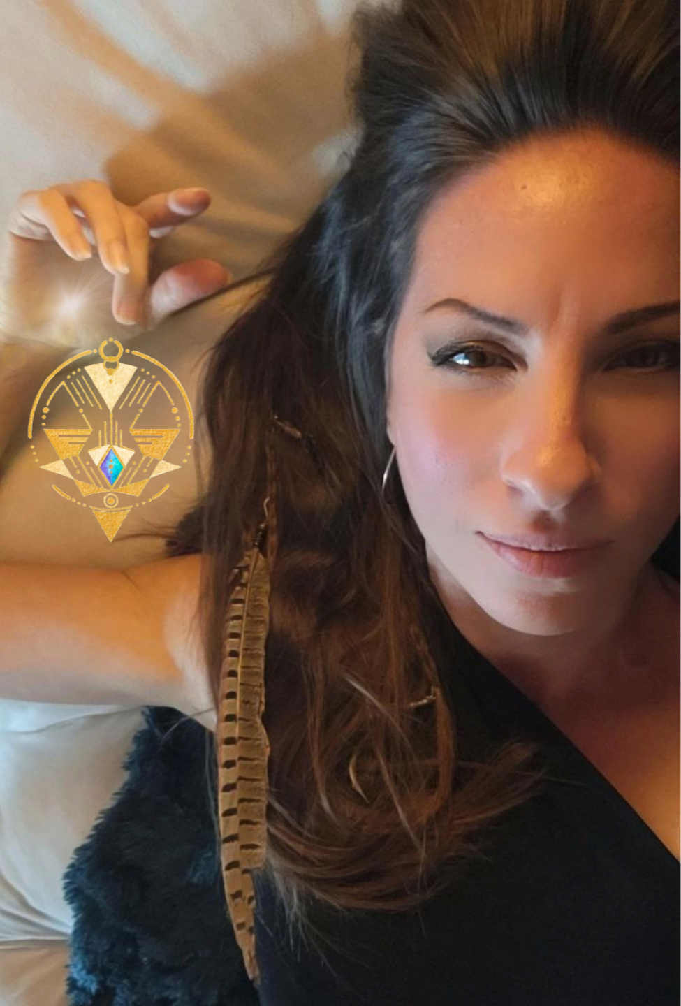 Feminine Embodiment Coach Emily Wehrman smiling with her gold spiritual logo.