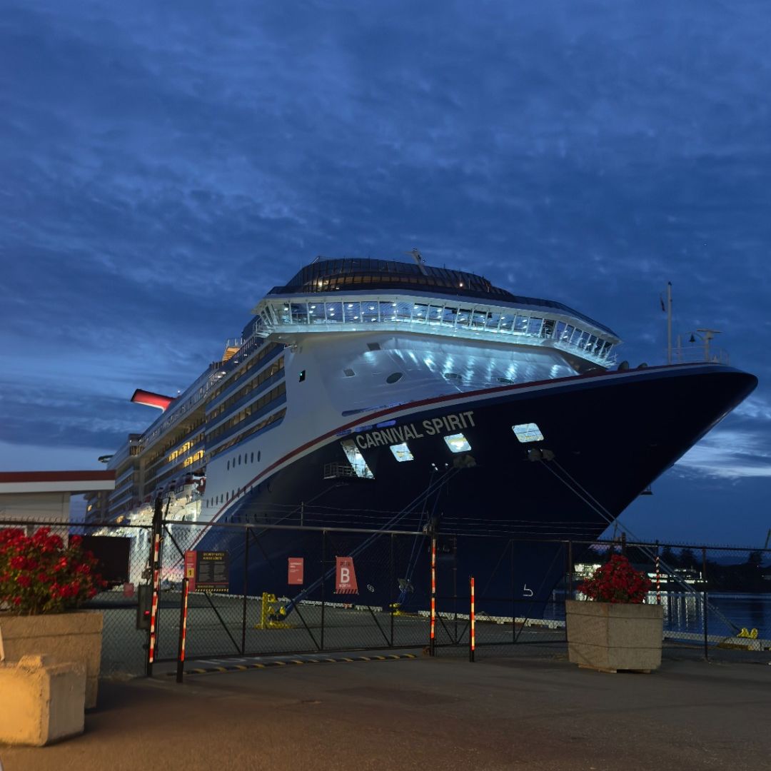 Victoria Cruise Port: Carnival ship docked with cars in foreground