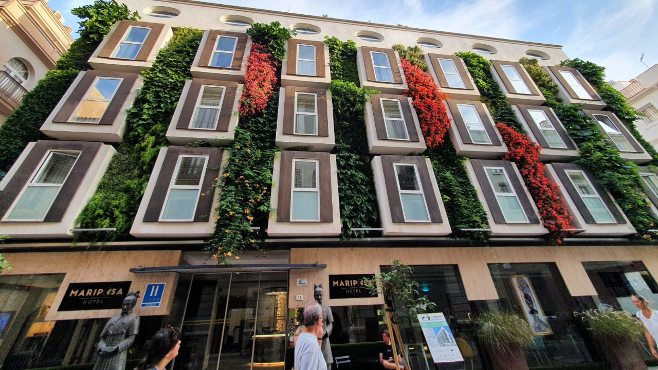 The hotel after, the same facade covered in plants
