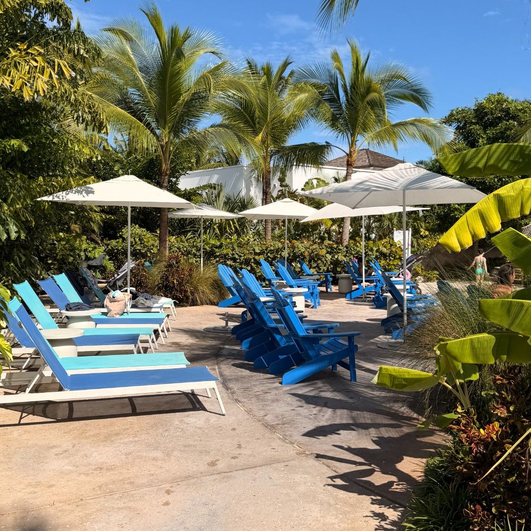 Baha Bay at Baha Mar: A shaded lounging area with blue and white chairs under umbrellas