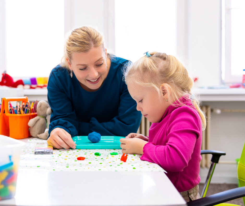 therapist working with young girl playing with play doh