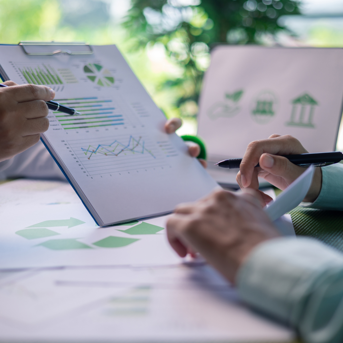 Professionals reviewing sustainability reporting documents in an office