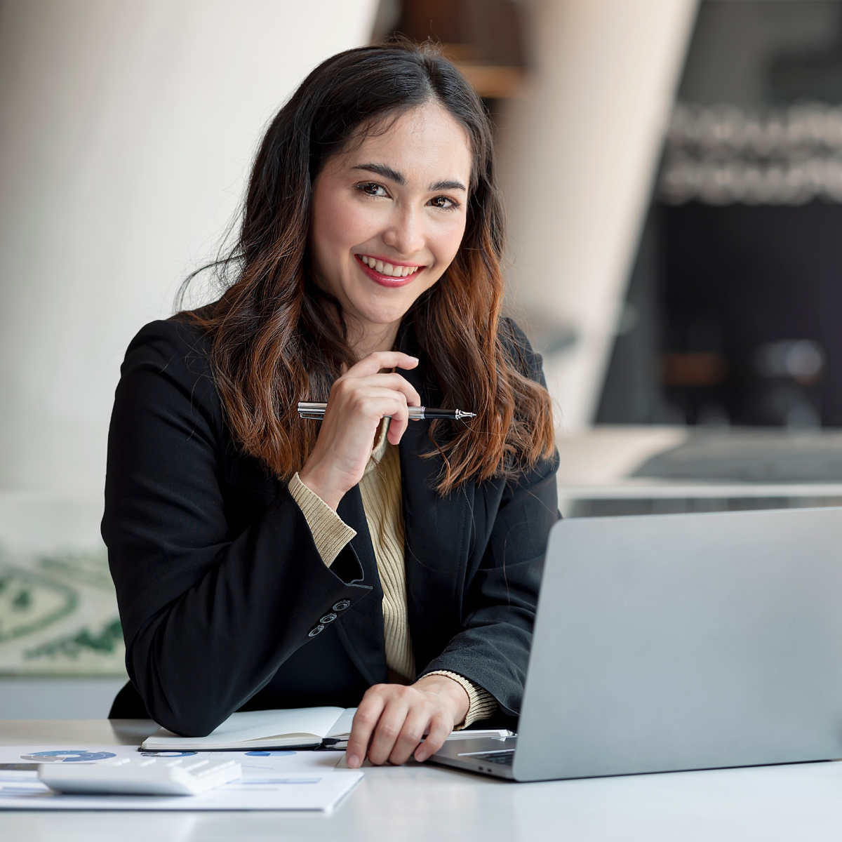 Professional woman working on sustainability reporting on her laptop in an office