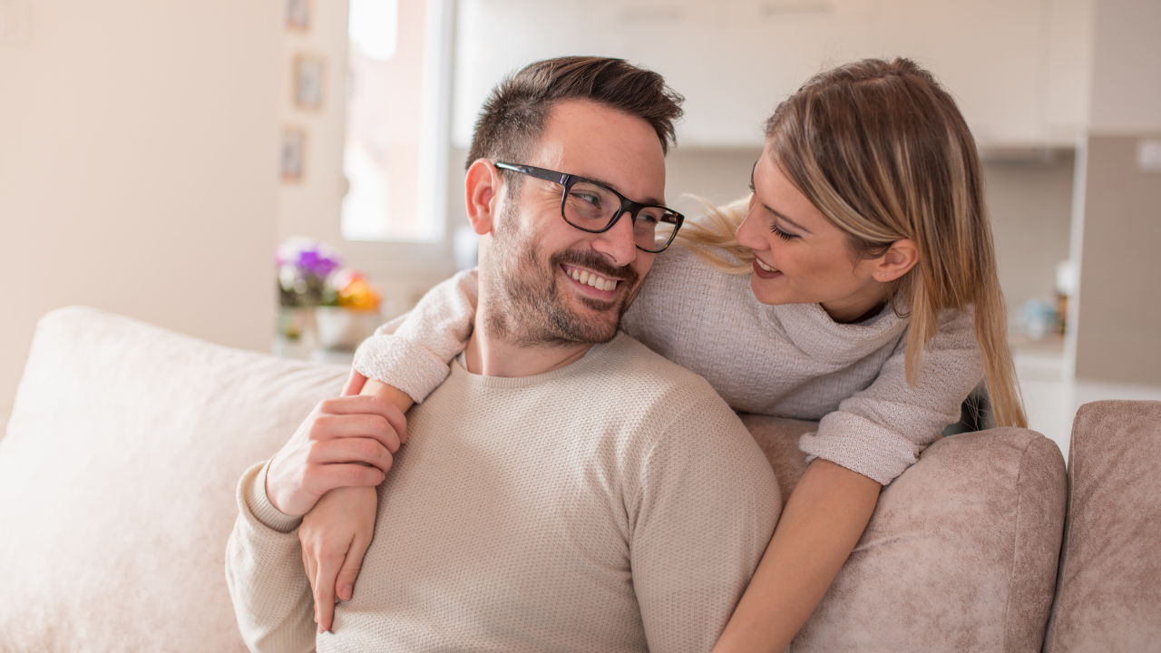 Loving couple on the couch hugging