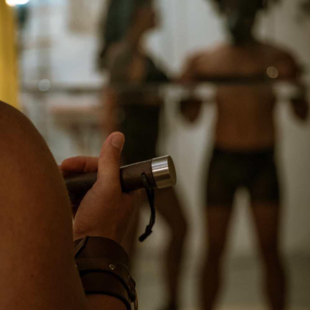 Atmospheric scene from a conscious kink workshop showing intentional power exchange, trust and embodiment without explicit sexual imagery