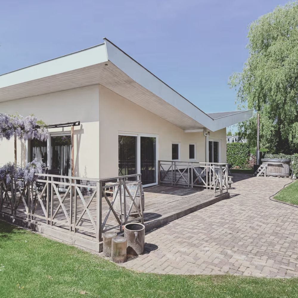 Black-and-white photo of a group of participants sitting in a circle during a Female Domination workshop, focused on conscious scene creation and power dynamics.