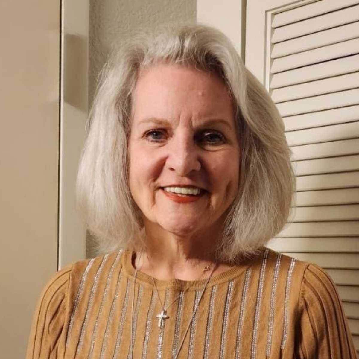 Photo of woman with white hair and yellow shirt