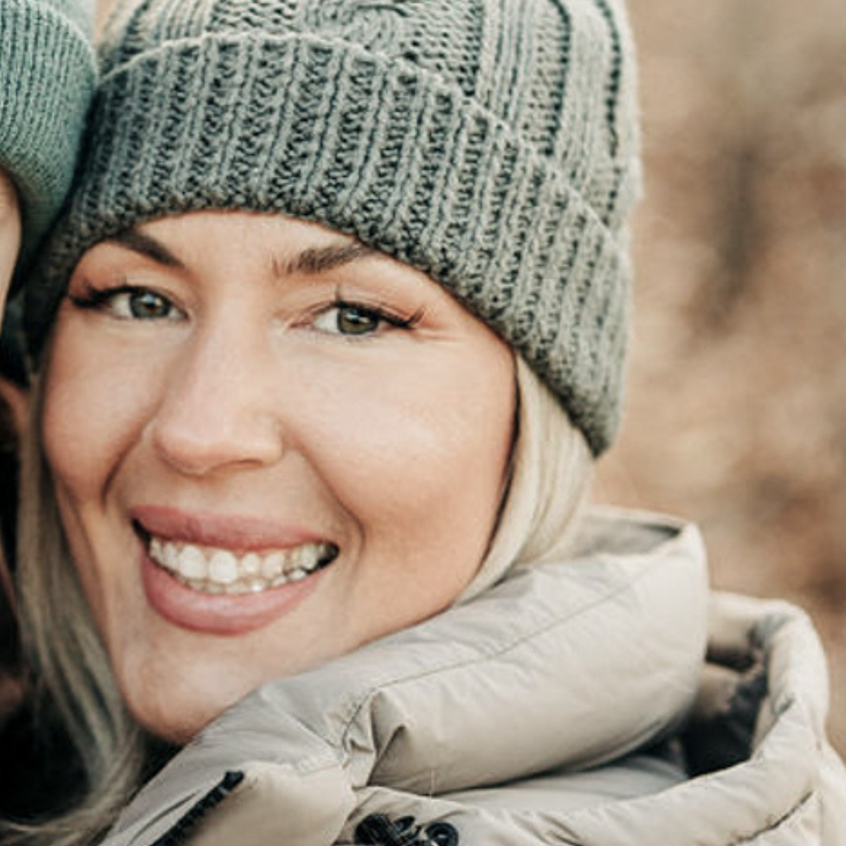 Image of woman with blonde hair and green beanie hat