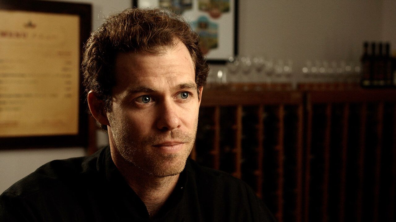 Image of man (Dylan Butterbaugh) in chef's coat