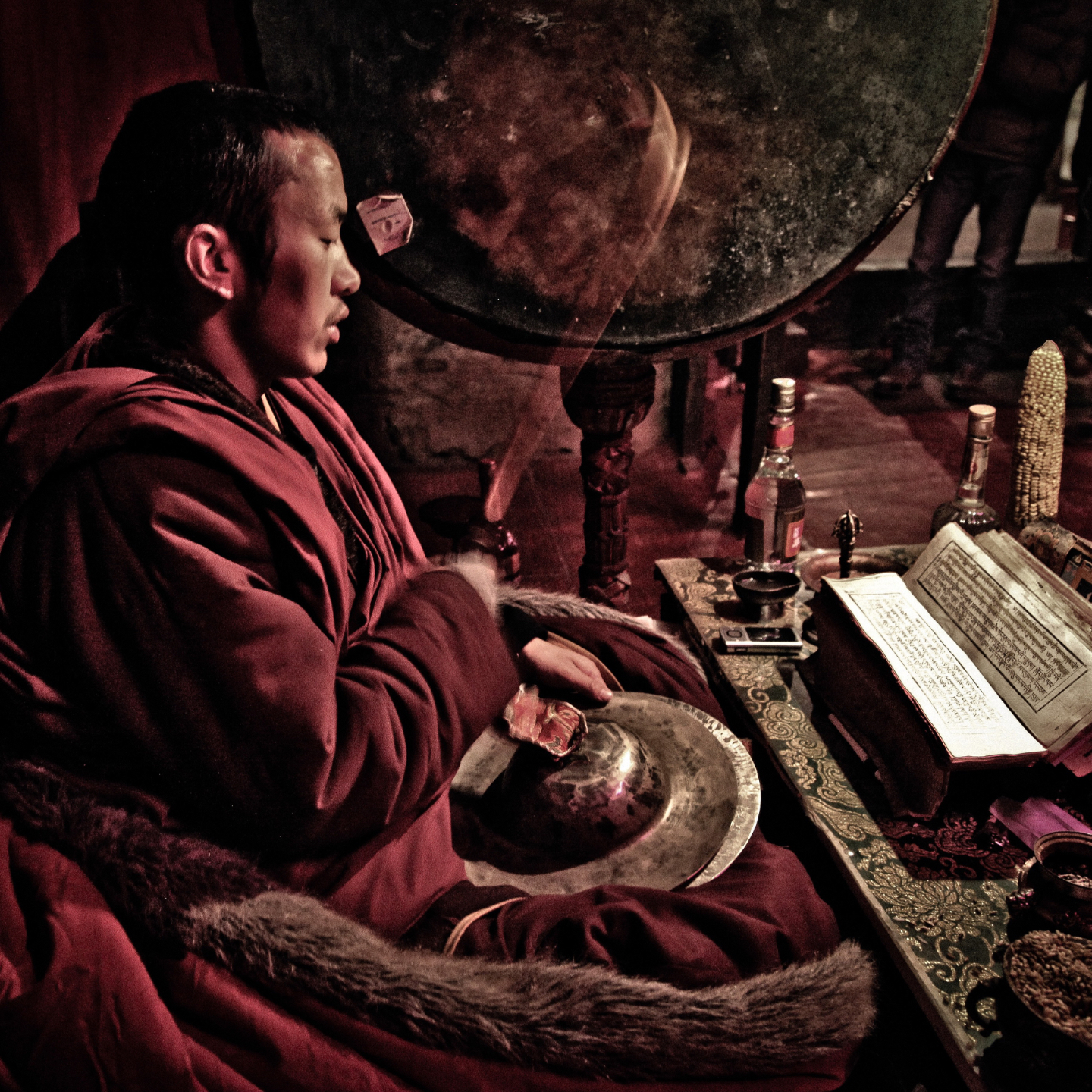 Traditional Tibetan shrine with a Guru Rinpoche statue and painted murals.