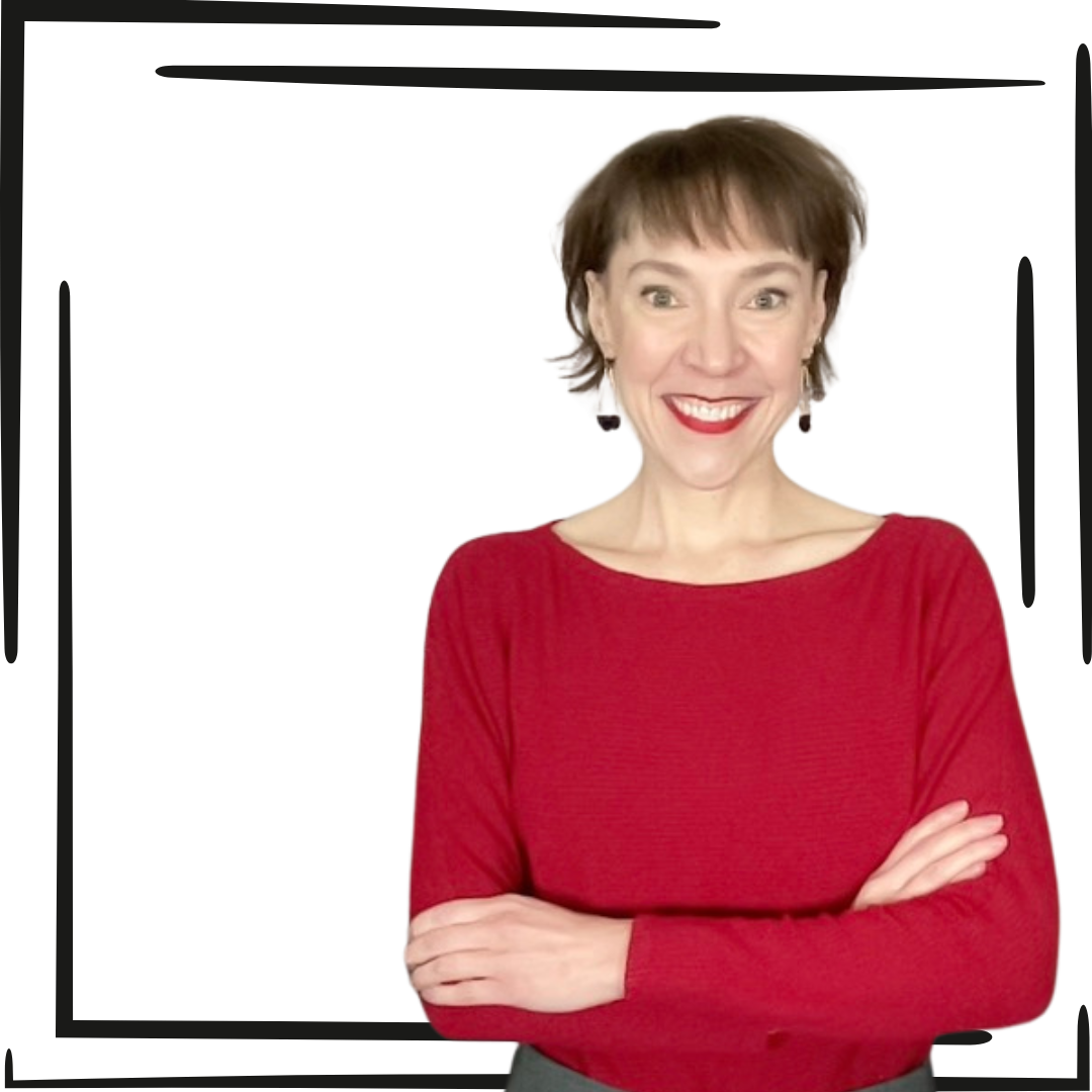 Penny in a red top with her arms crossed smiling at the camera