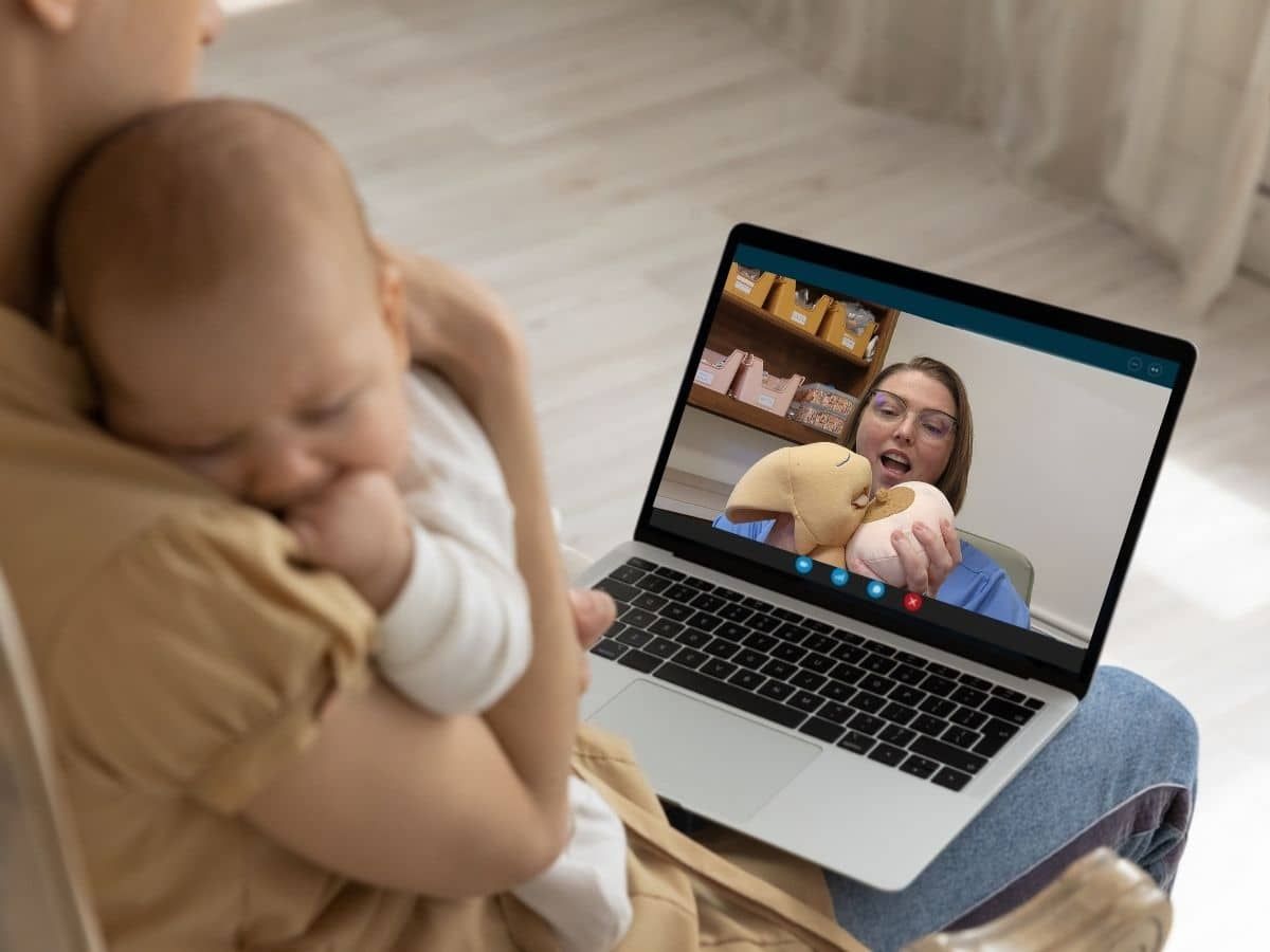 Avery Young demonstrating latching techniques during the Reflexive™ Latching Masterclass to achieve a deeper, pain-free latch.