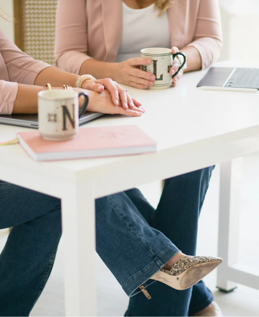 six figure business owners by a desk discussing their financials