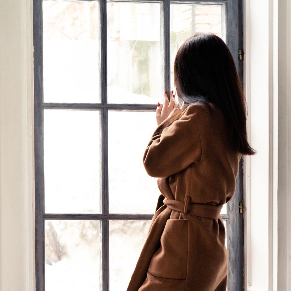 Minimal neutral woman at window