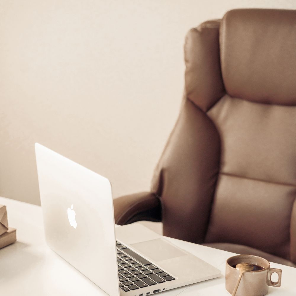 Minimal neutral laptop and desk chair