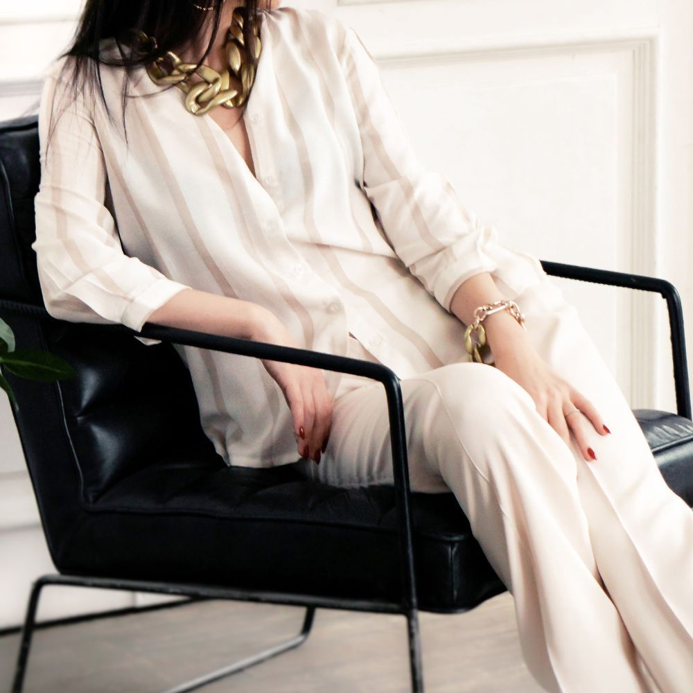 Minimal neutral casual woman sitting in chair