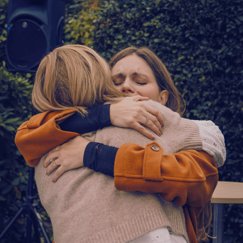 Two women hugging - lots of emotion.
