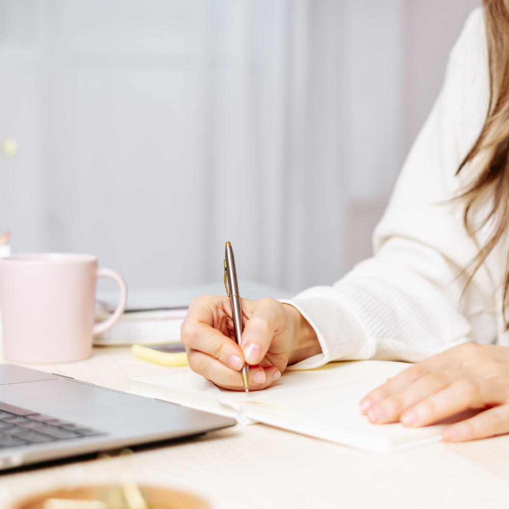 Woman writing with a pen on paper