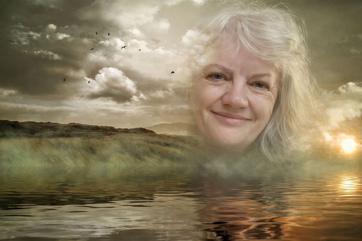 Double exposure image showing Deborah Christensen's face emergng from a placid river landscape. 