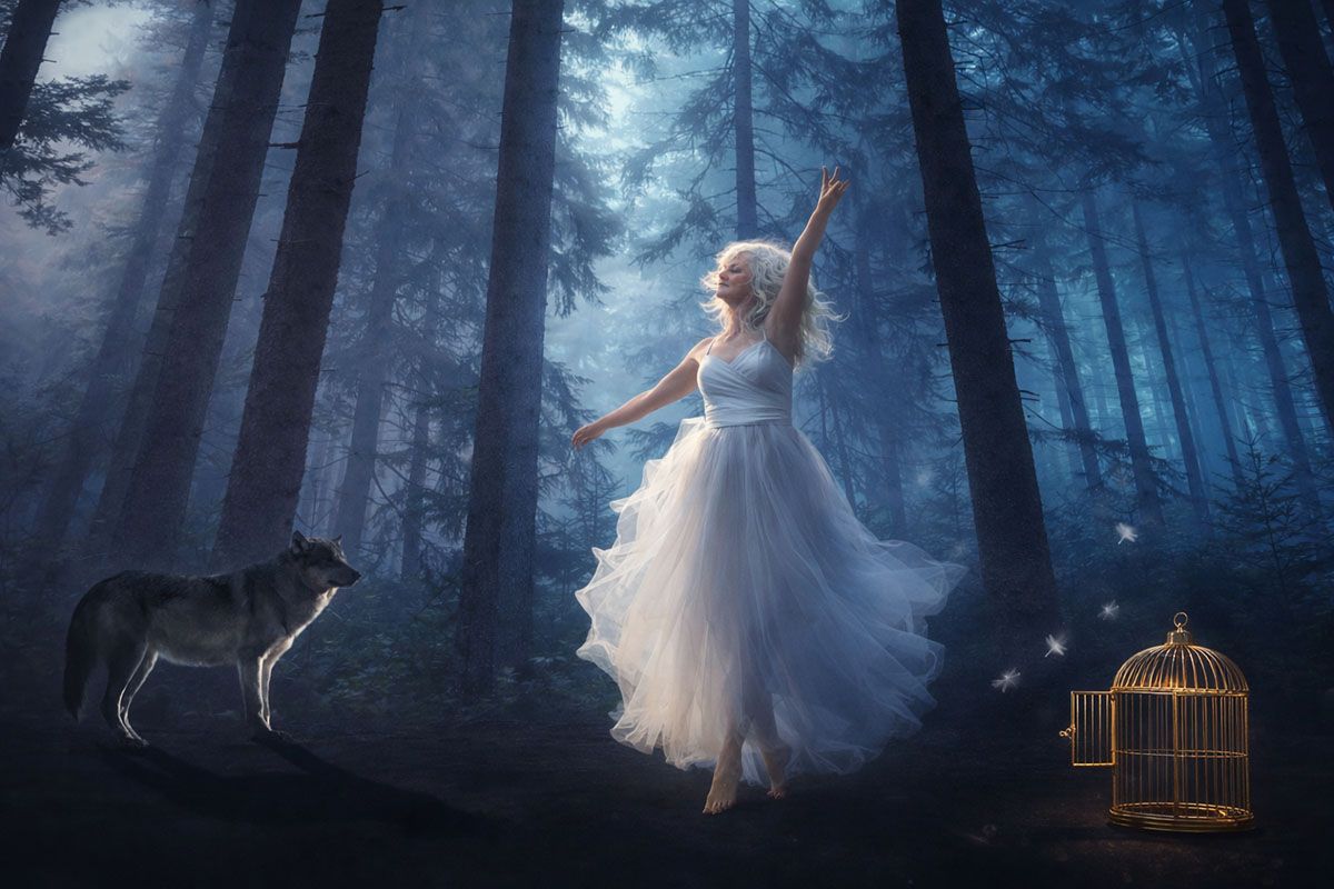 Fantasy Image of Deborah Christensen with wolf in a moonlit forest.