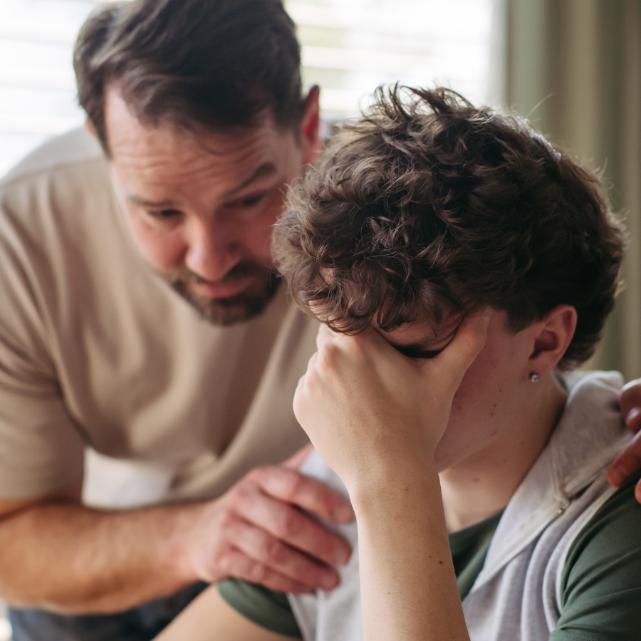 dad talking calmly with teen daughter