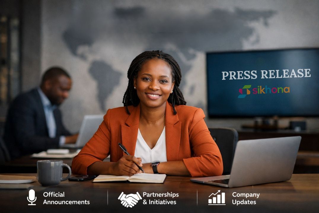 Professional woman in an orange blazer sitting at a desk with a laptop and pen, smiling at the camera. A screen behind her displays “Press Release” with the Sikhona logo, and office-themed icons along the bottom labeled Official Announcements, Partnerships, and Company Updates.