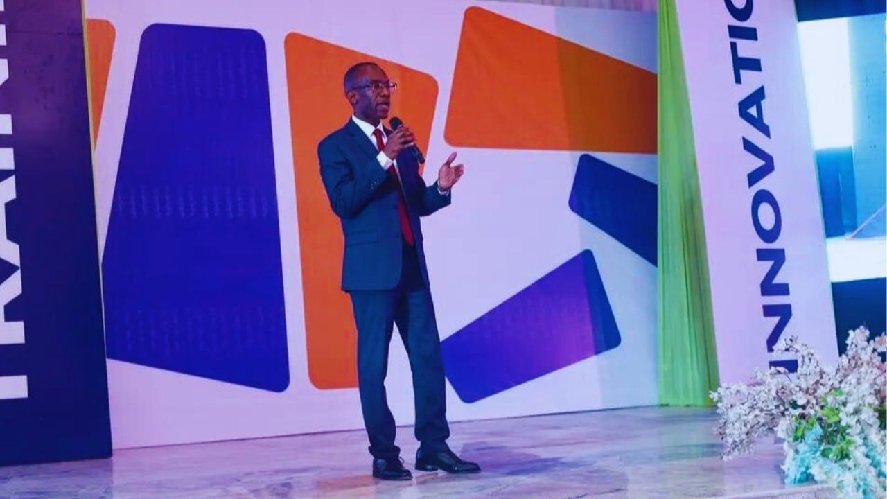 Dr. Michael Thompson standing at a podium, speaking to an audience.