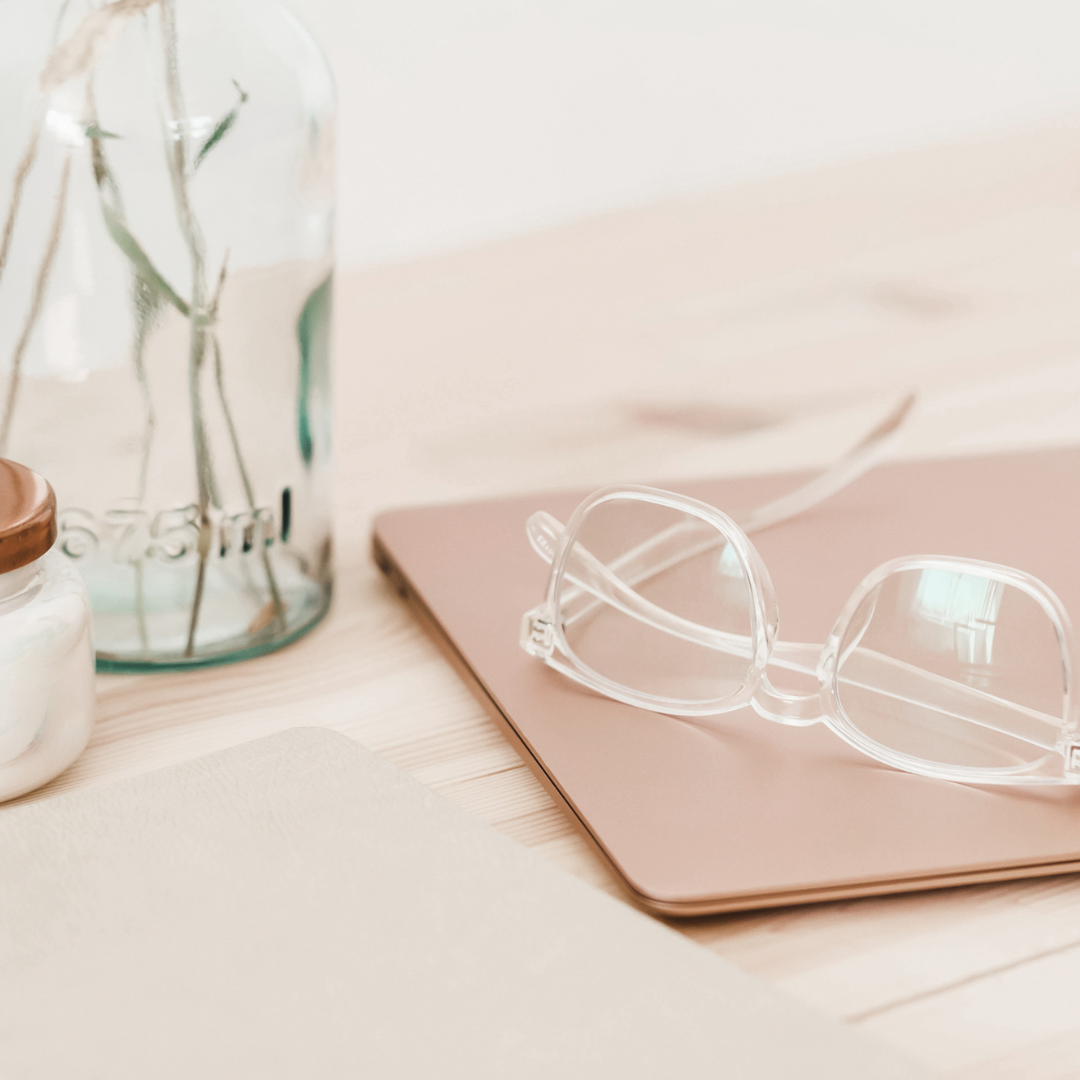 laptop on desk with glasses