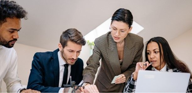 four people working at a table